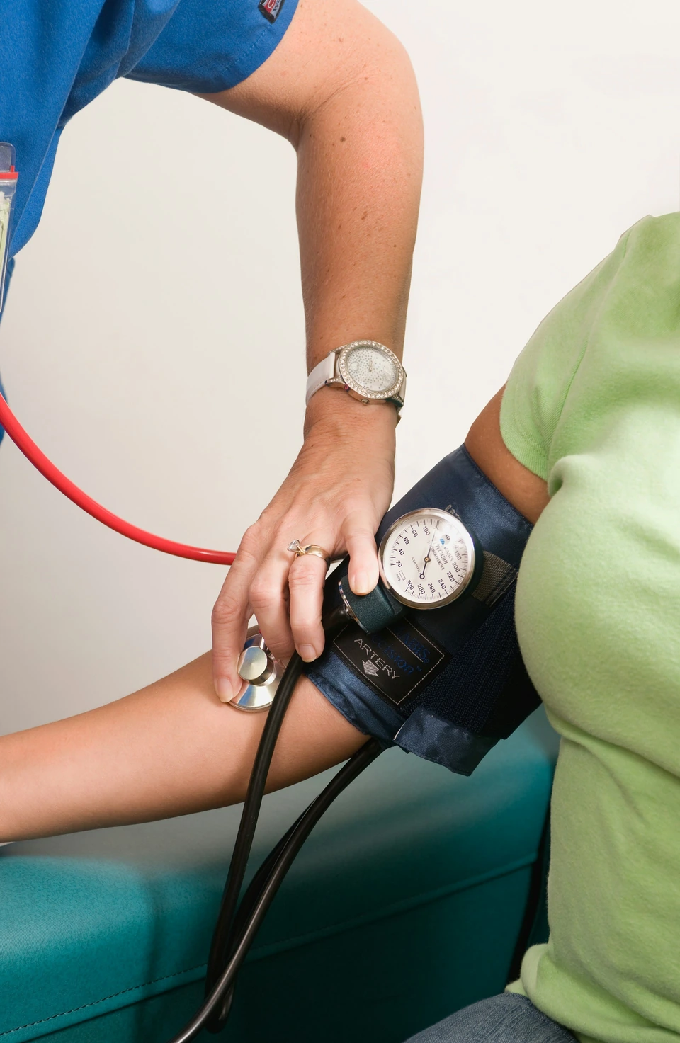 A healthcare professional checking a person’s blood pressure.