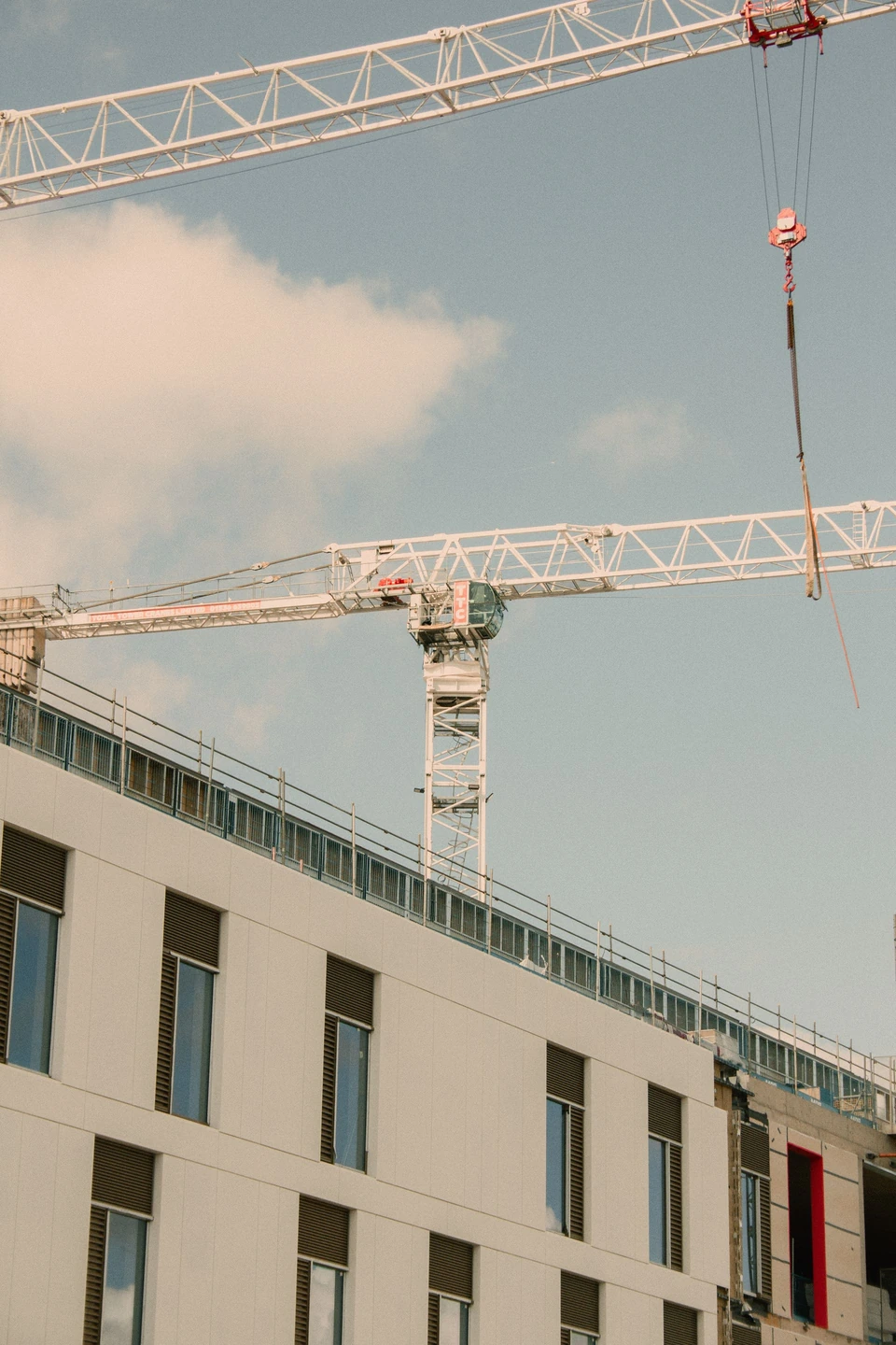 Cranes above a building under construction.