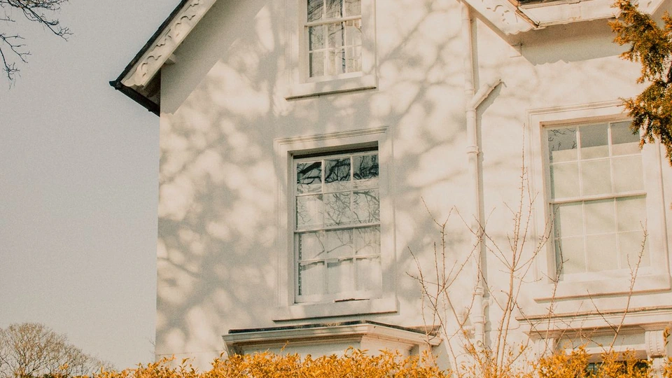 The front of an English house in warm sunlight.